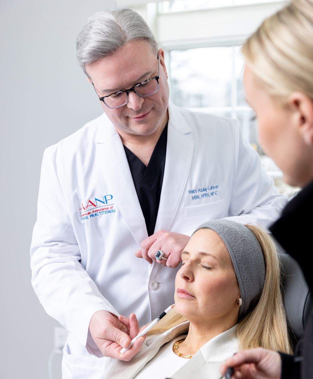 Matt Azulay-LaFever and a student model injecting dermal filler into the chin of a patient model