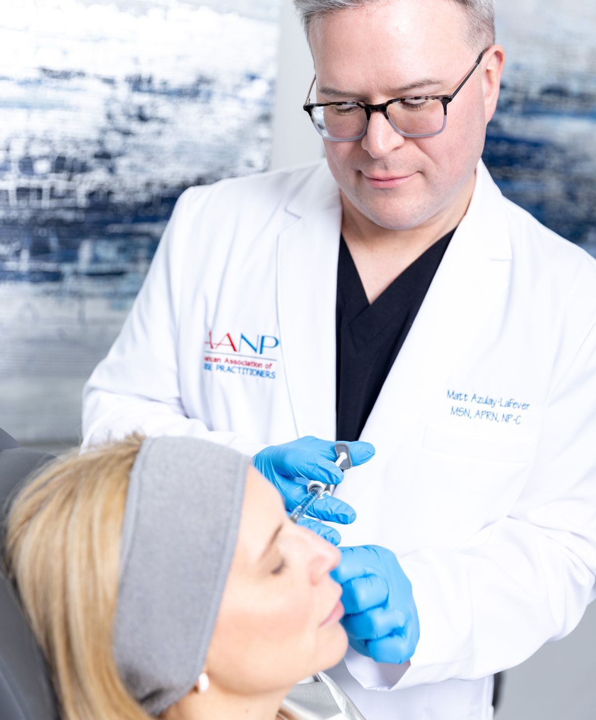 Matt Azulay-LaFever giving a patient model a dermal filler injection